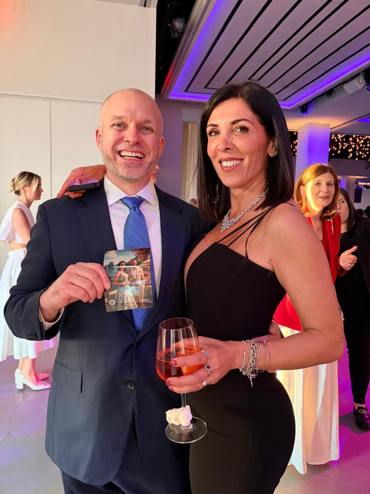 Proud guests holding their printed AI portrait as a keepsake.